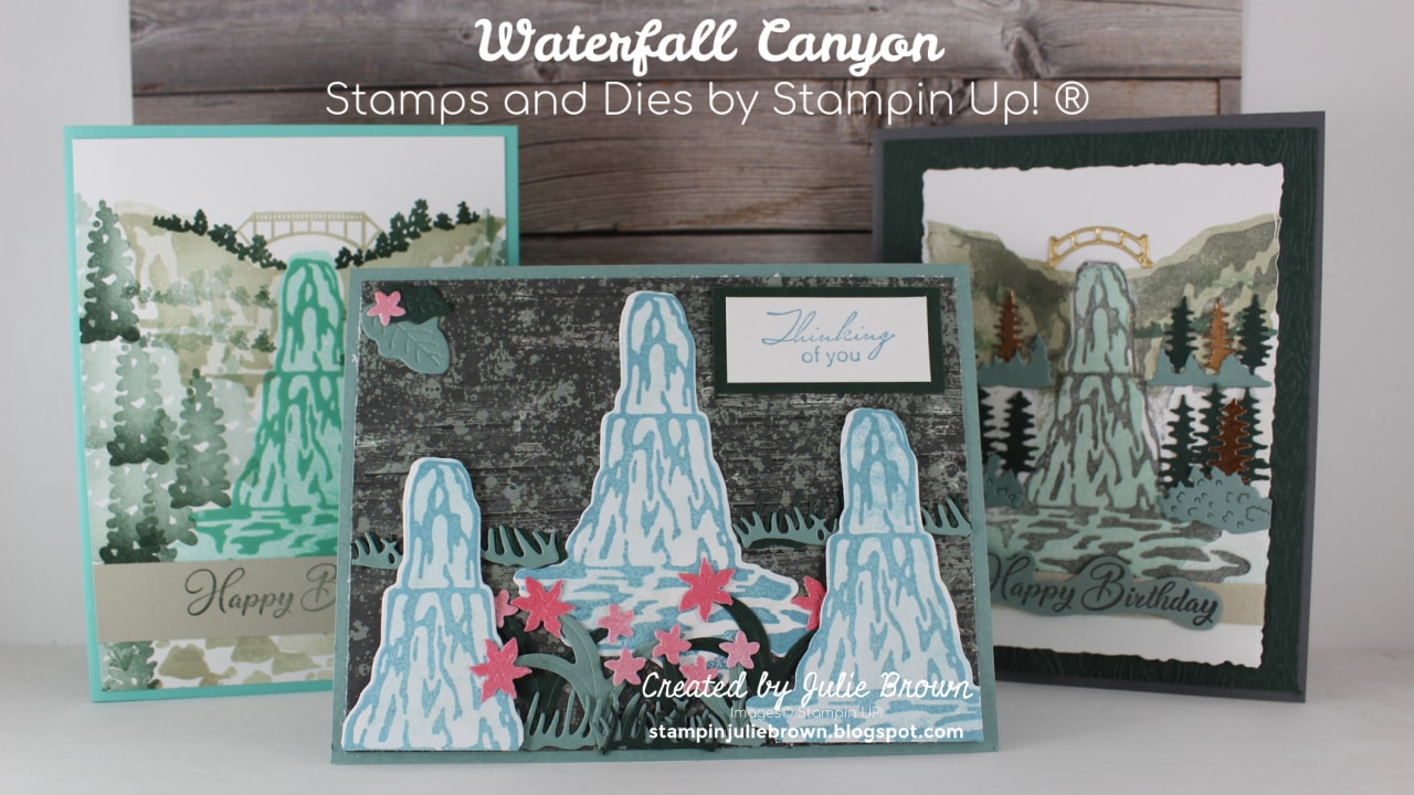 Three cards made with the Waterfall Canyon Reversible stamp set. Two behind are portrait and are mostly covered by the third horizontal card in center. Card has Designer Series paper as background with Three stamped waterfalls that have been die cut and layered on card front with die cut grass, flowers and leaves.