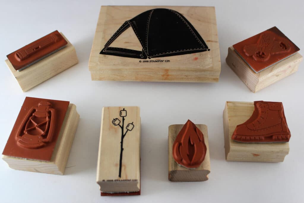 Several wood mount stamps with a camping theme to show example of wood mount stamps, shows both back side and front of blocks