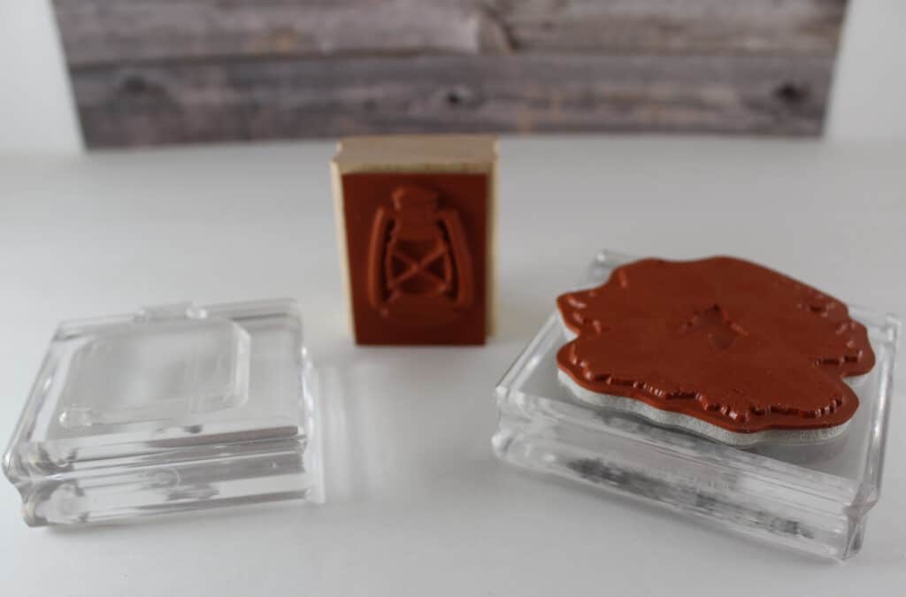Three types of stamps, Lantern wood mount stamp in center, photopolymer laying flat on clear block on left and cling stamp on clear block on right.