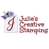 Julie's Creative Stamping logo has a stitched label on the left with a cursive J in the middle and on the upper left side of label a light purple butterfly, flower and green leaves interwoven. On the right side of stitched label are the words Julie's Creative Stamping in Merry Merlot color.